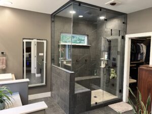 A new shower installation with grey tiles and large glass panels in Cary