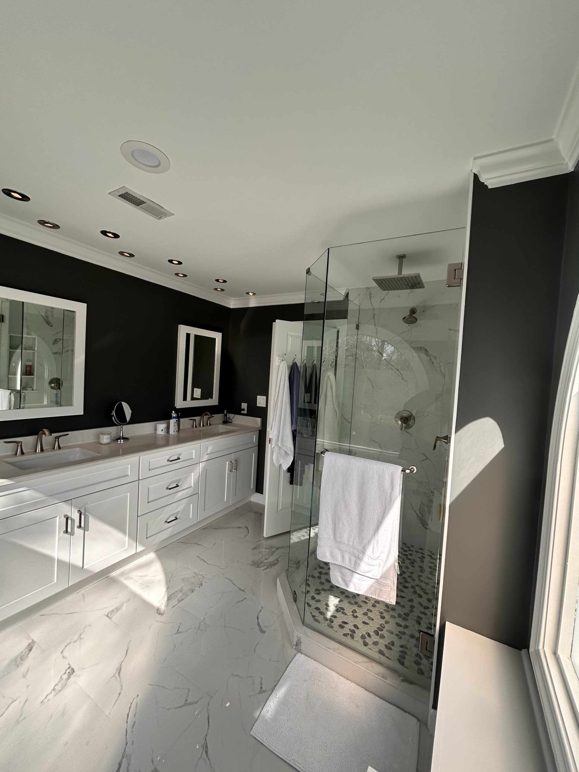 Completed bathroom remodeling project with coordinated shower, vanity, storage, lighting, and finish selections