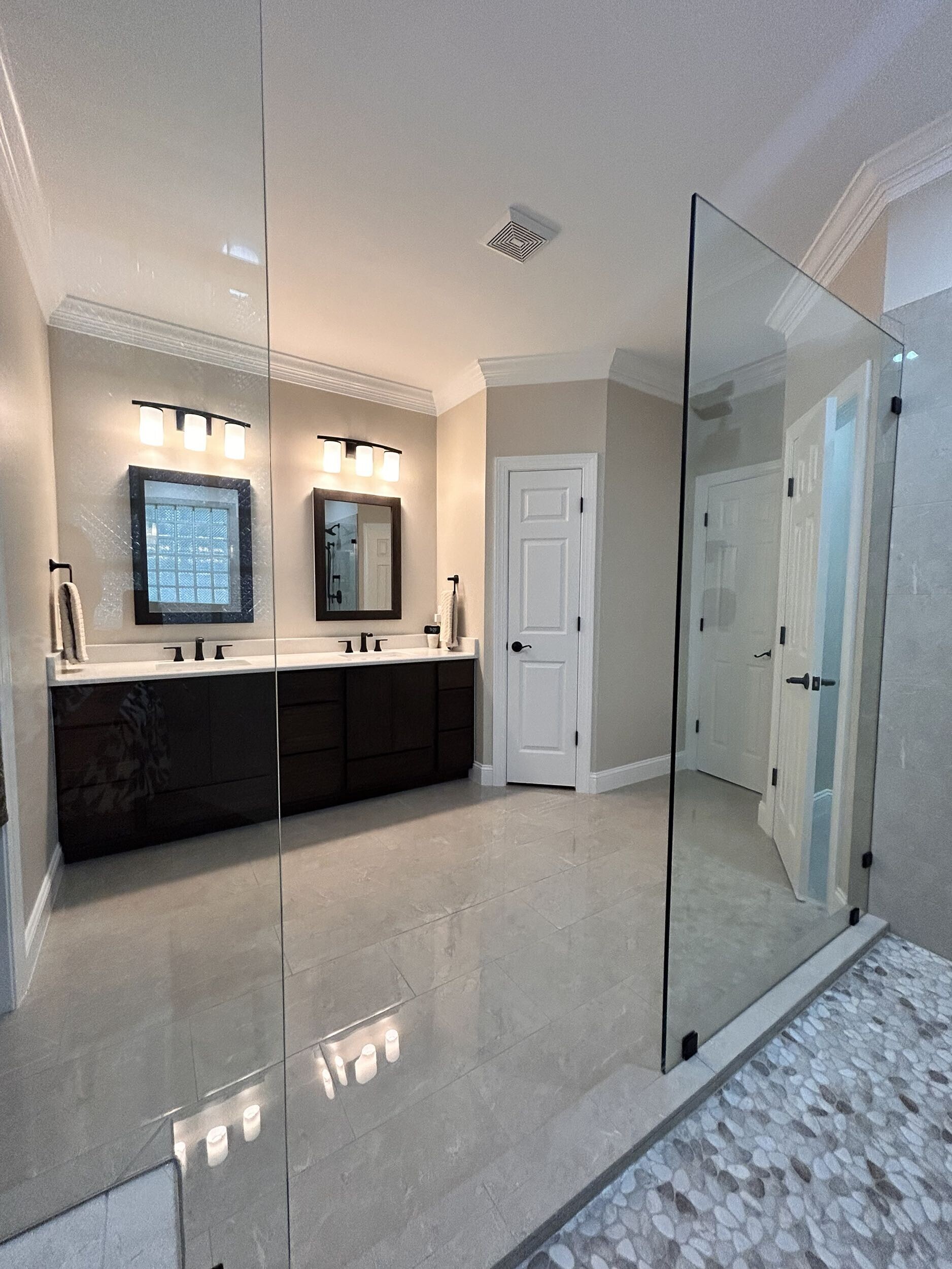 Finished bathroom renovation showing coordinated layout, shower, vanity, storage, and material decisions