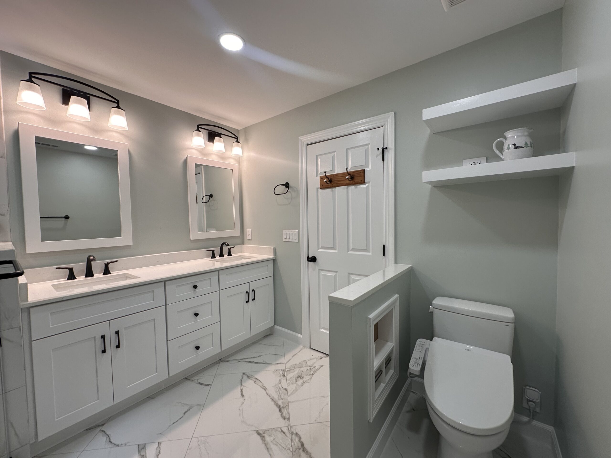 Completed bathroom renovation with coordinated shower, cabinetry, tile and fixtures